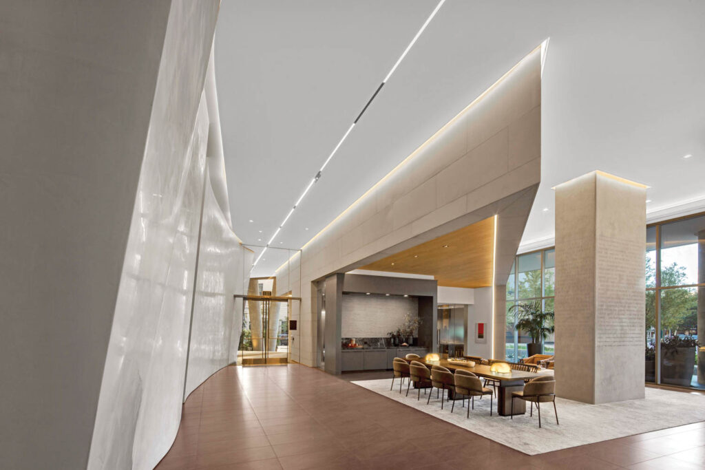 sleek lobby space with fireplace and table with chairs