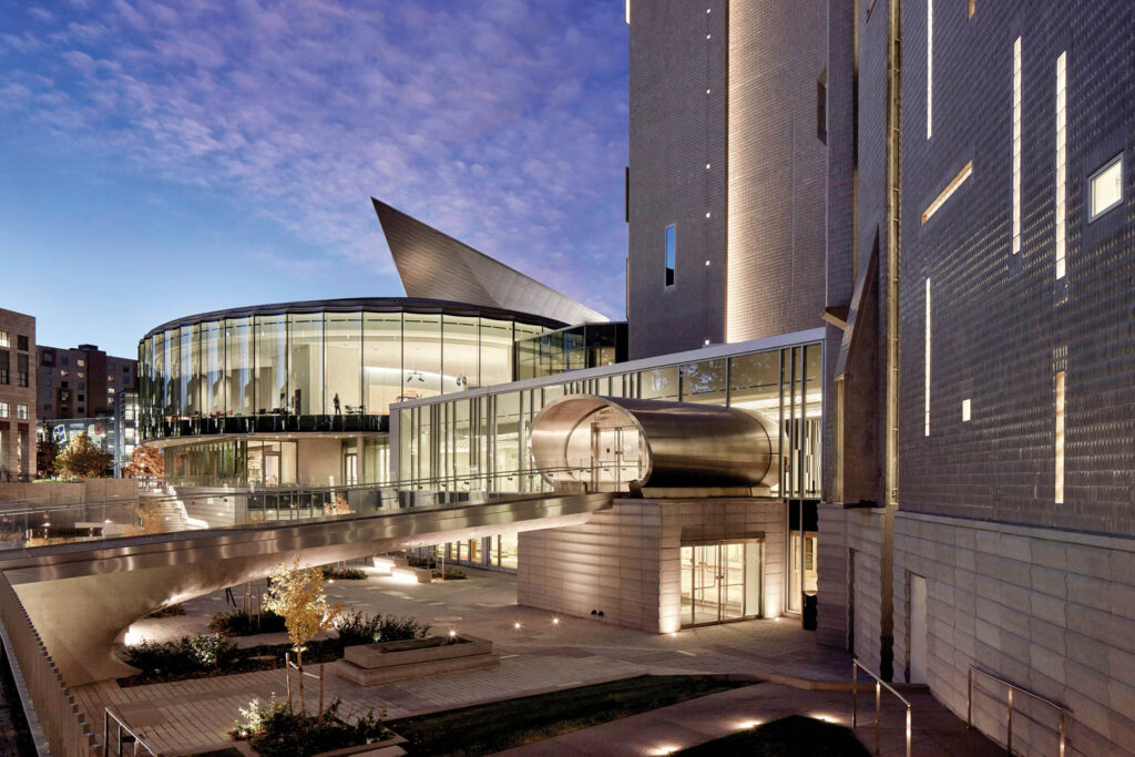 the exterior of the Denver Art Museum lit up at night