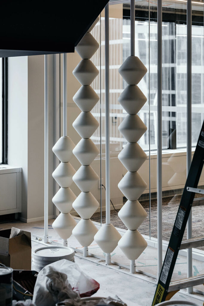 On-site, the beads for the partition were strung on floor-to-ceiling metal rods fitted with rubber gaskets.