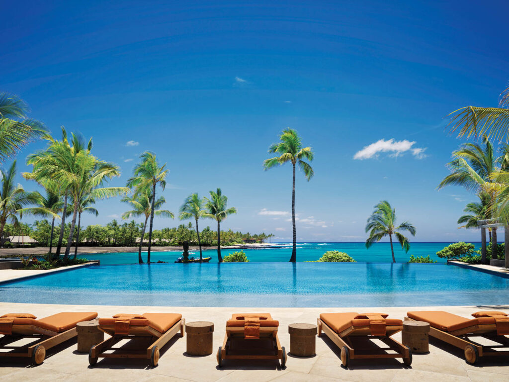 a resort pool overlooks Kahuwai Bay