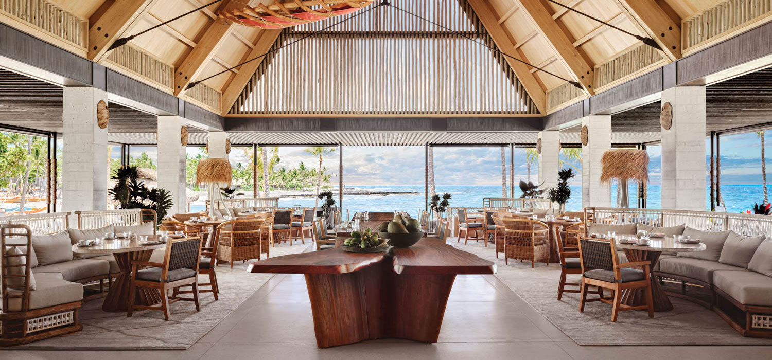 an installation of canoe sails hangs over a mahogany table in this hotel restaurant