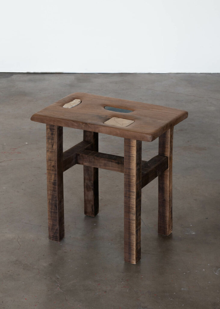 lone wooden low table in a gallery setting