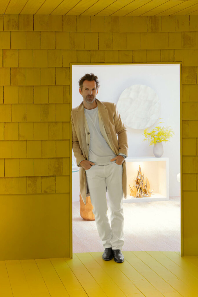 Mathieu Lehanneur standing in a yellow doorway