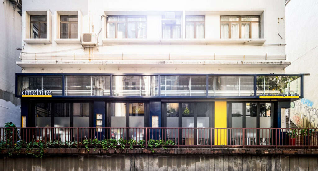 exterior of studio in Hong Kong with white facade and black bars