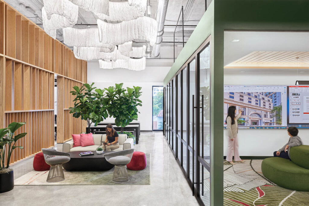 a bright office common area with greenery