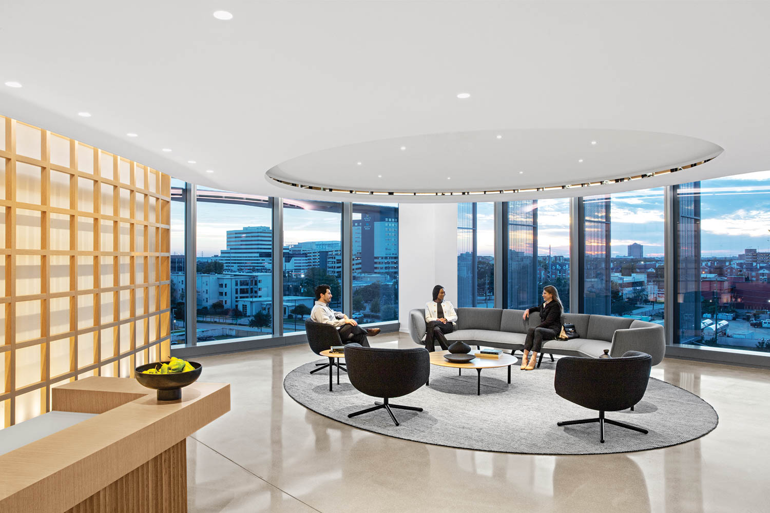 seating area with black chairs and floor to ceiling windows facing the city