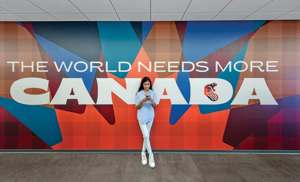 The World Needs More Canada mural on a corridor wall
