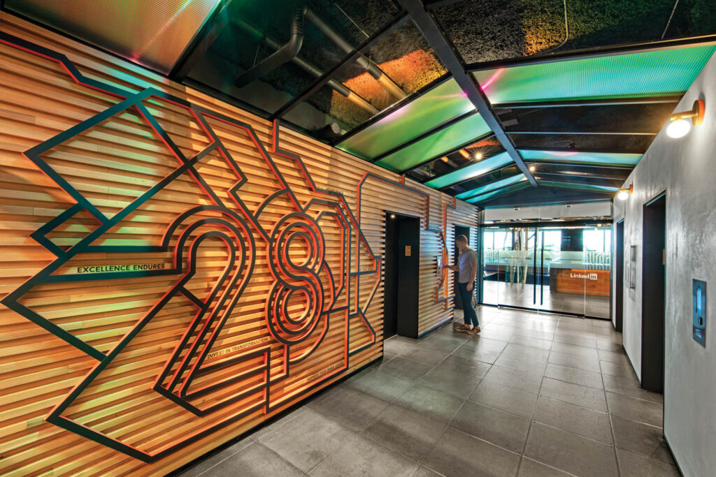 main elevator lobby with wooden slats on walls and bright wayfinding graphics
