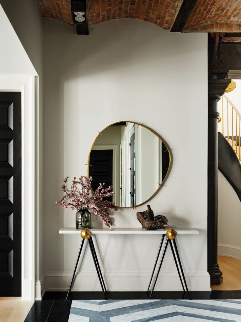 entry with white oak console and round mirror