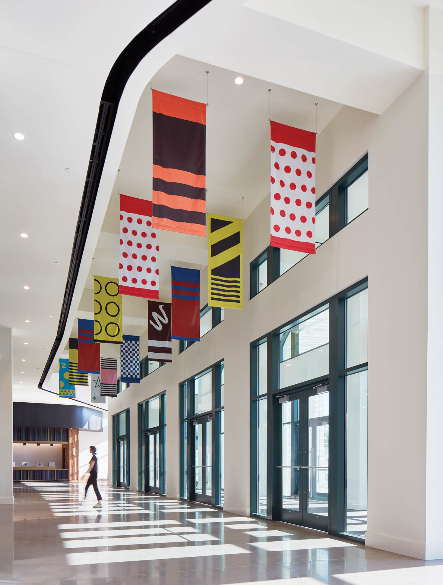 interior hallway of racehorse stadium with lots of flags