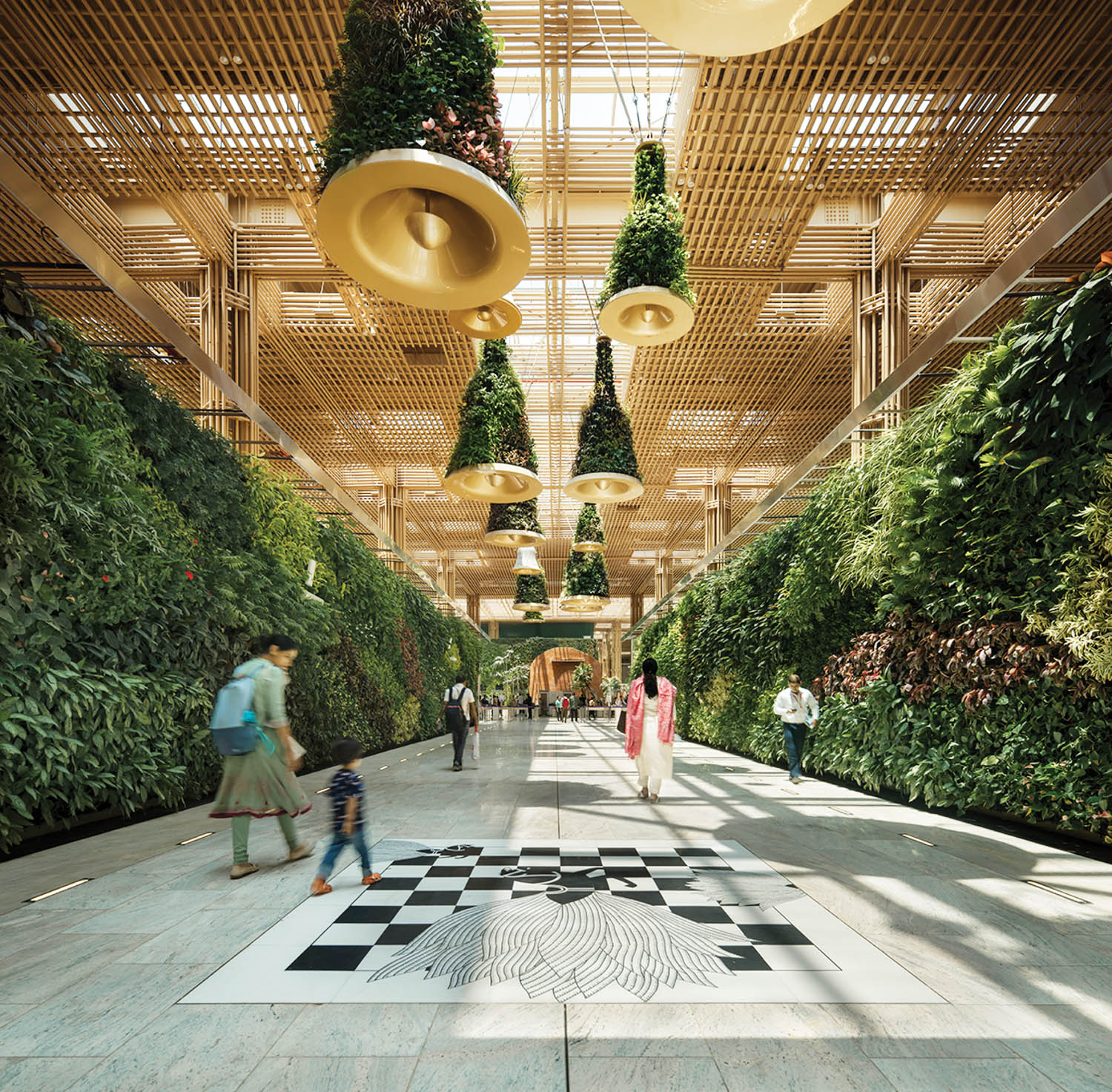 walkway with view of the shrubbery and greenery and bell decorations all around