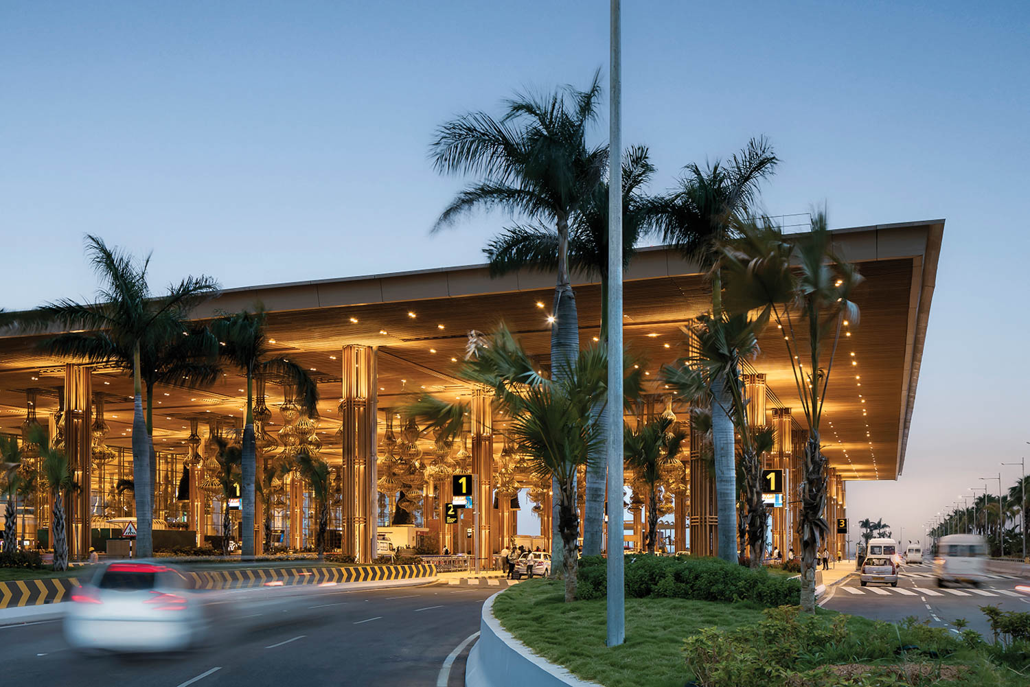 exterior of airport area with lots of palm trees and bright lights