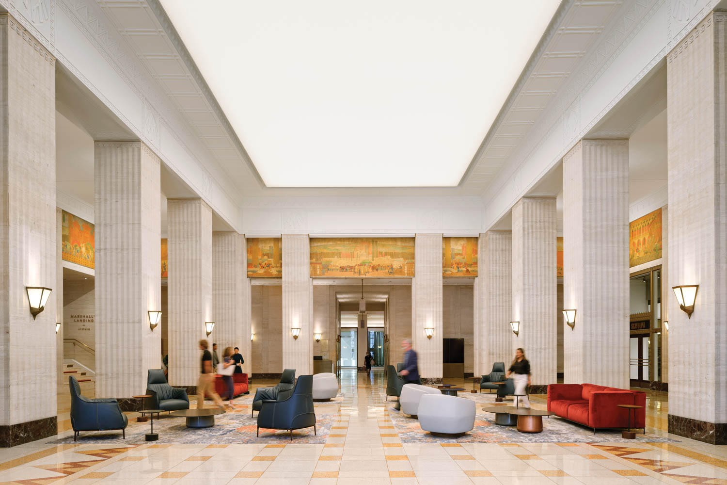 large gallery room with white columns and multicolored seating