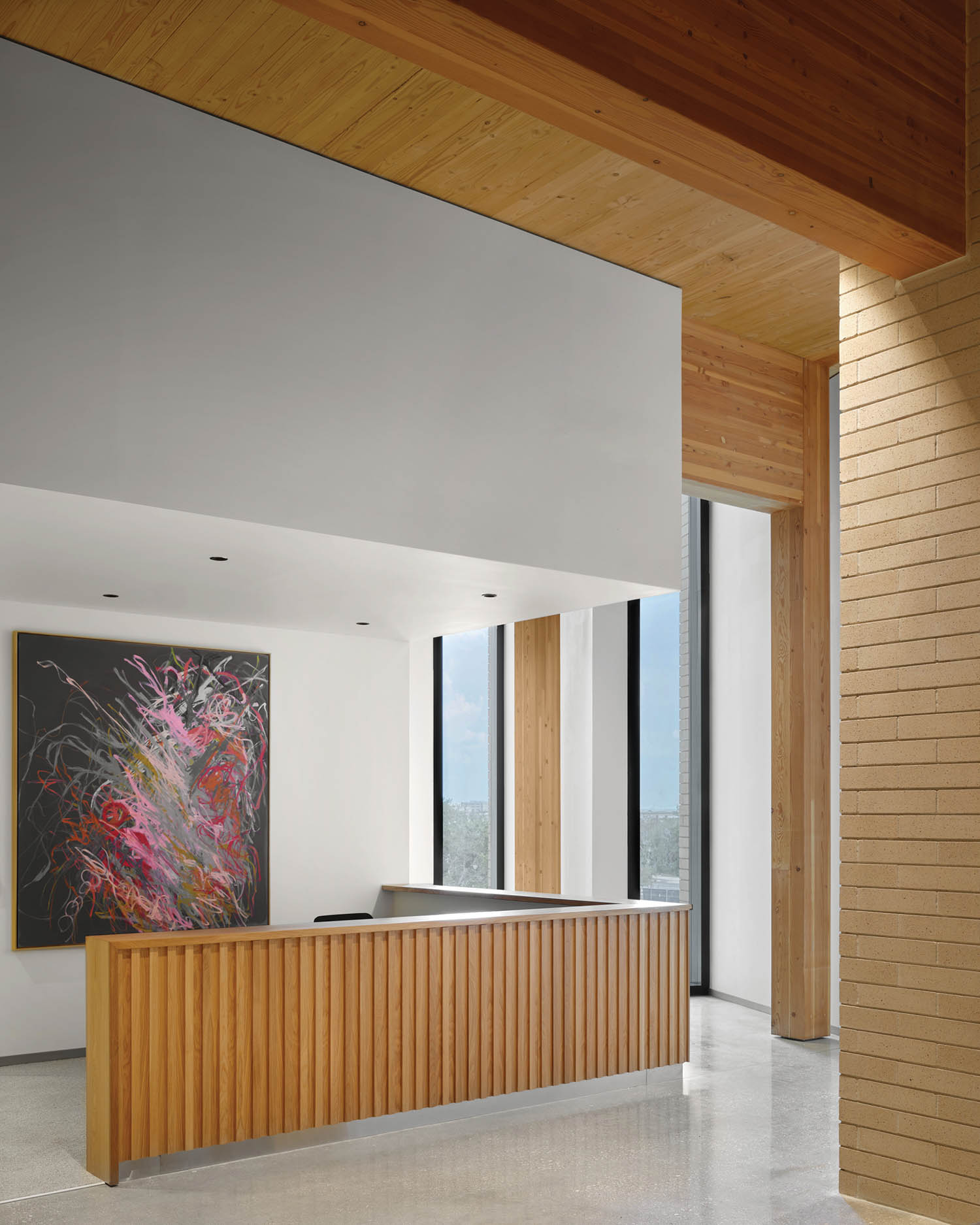 reception area with bright artwork and wooden dividers