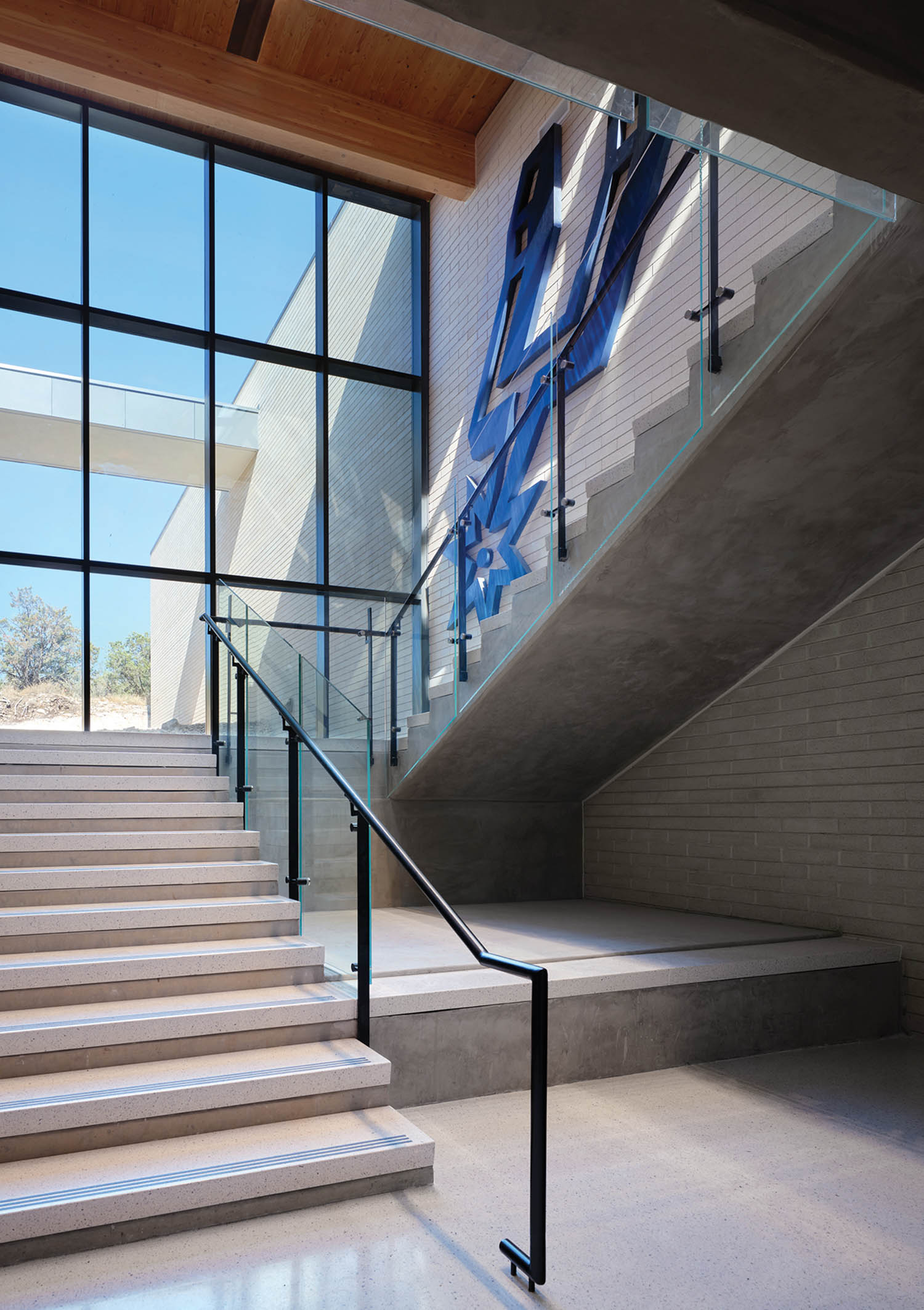 stairwell area with graphic blue art on the wall