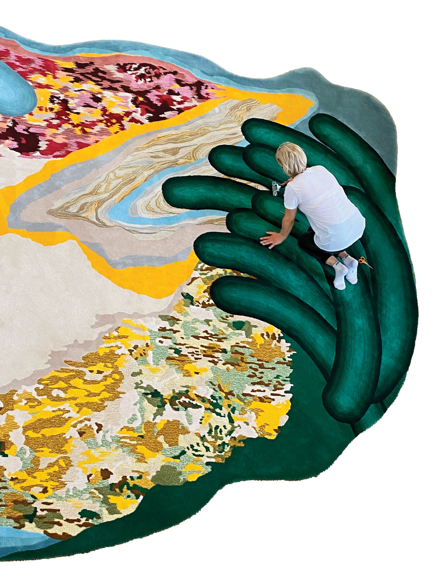 artist Bina Baitel sitting on top of a green hand which spills out into the surrounding scenery