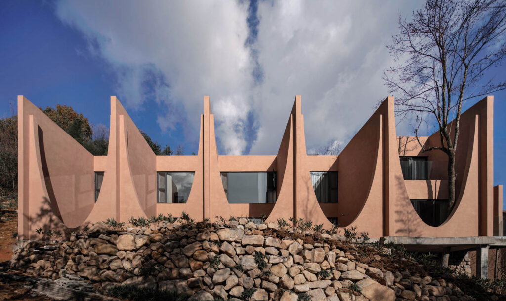 circle of structured pillars above a rock wall