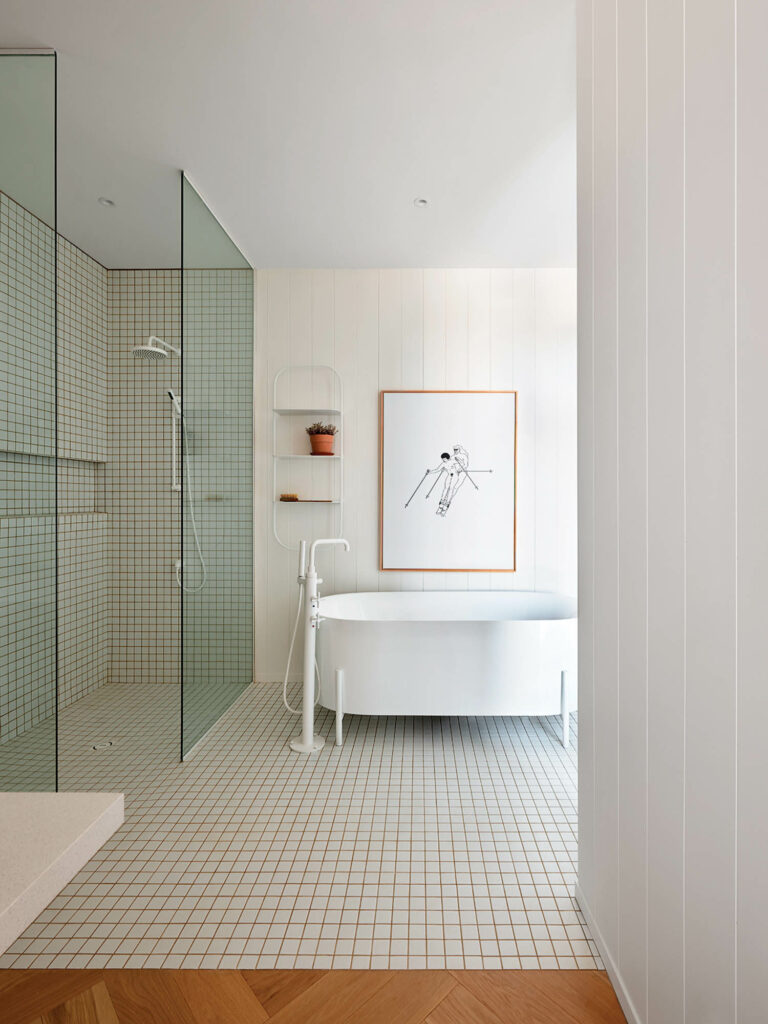 white bathroom with glass shower and white bathtub