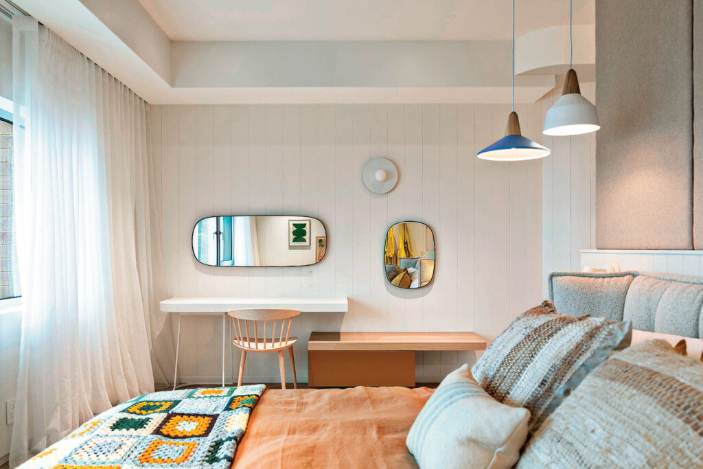 bedroom with mirrors and orange bedsheets