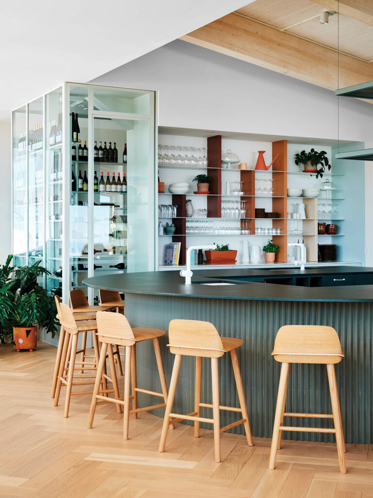 indoor bar with wooden stools and fully stocked bar