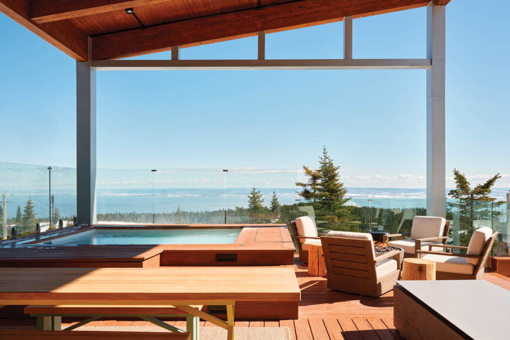 outdoor deck with hot tub and open view of the surrounding scenery