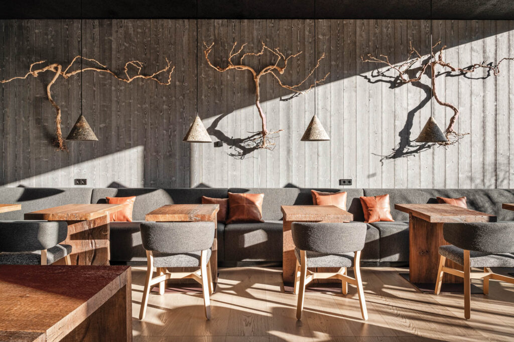 dining room with oak chairs below hanging chandeliers