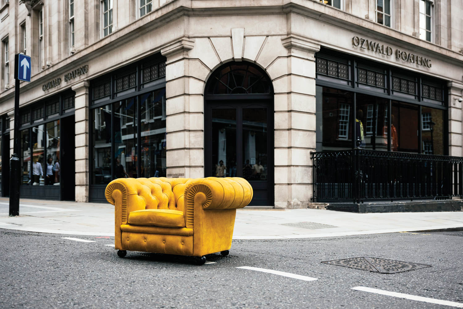 yellow armchair on the middle of the street