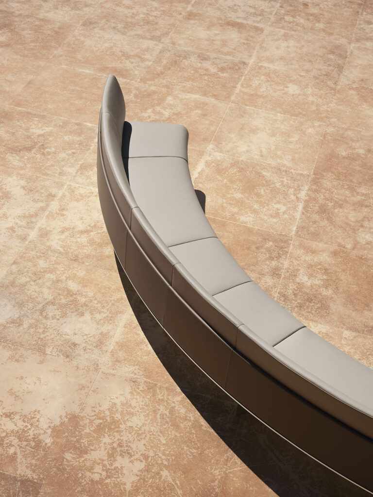 long curved couch on a tile floor