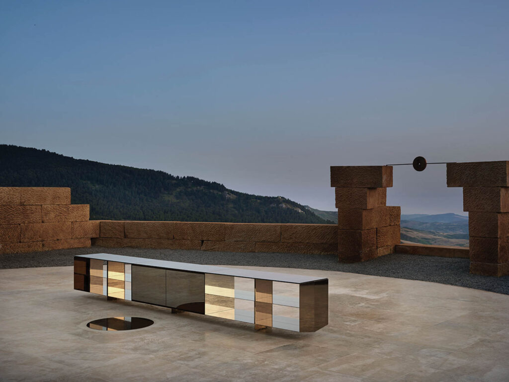 rectangular block on a round platform surrounded by the mountains